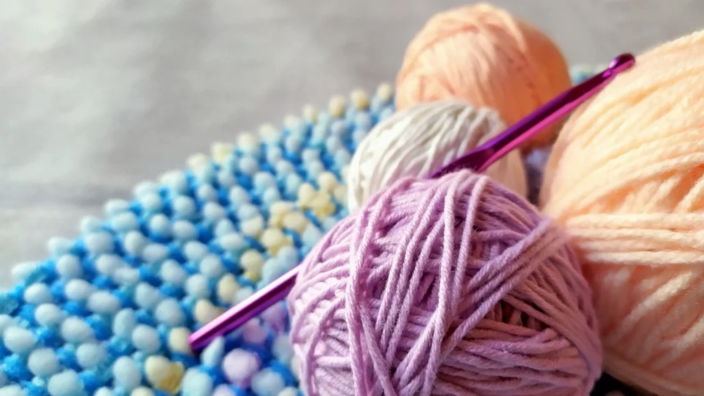 Balls of yarn and a crochet hook