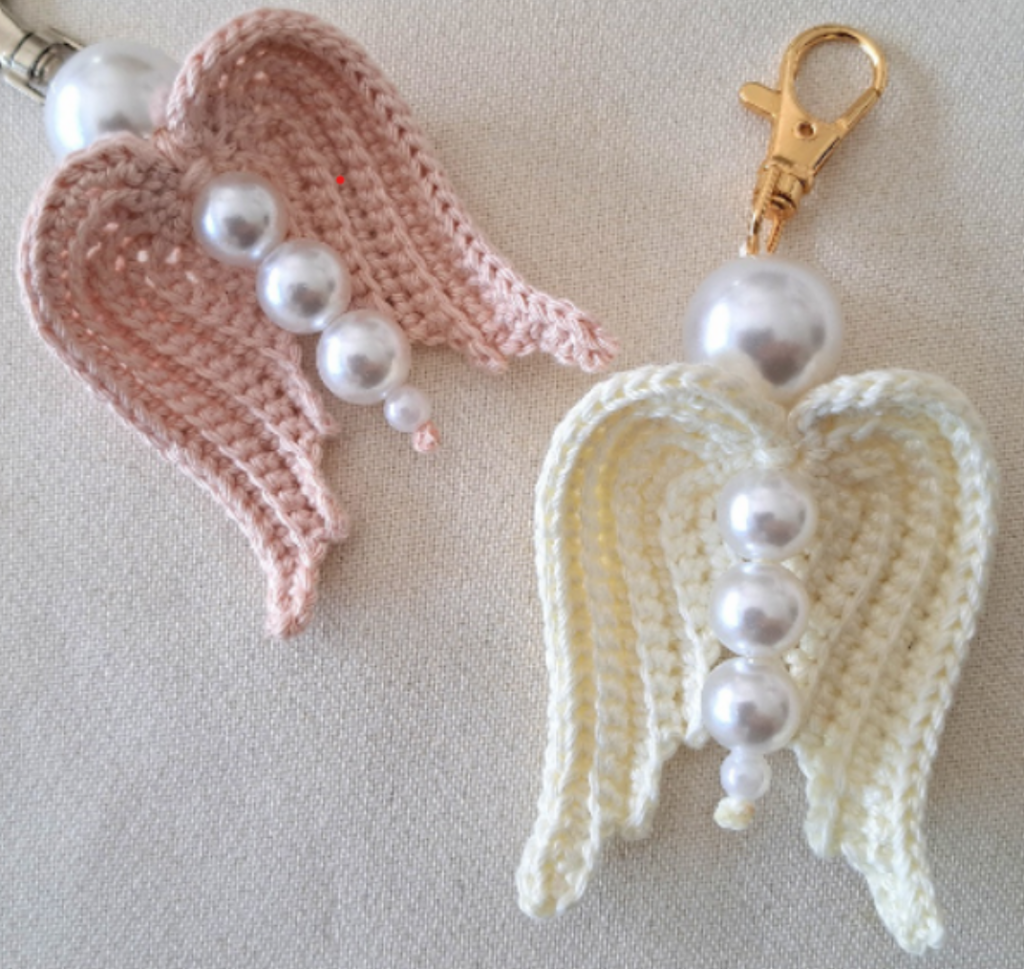 Picture of two crochet angel wings key chains with pearls